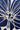 A close-up of a navy blue and off-white patterned fabric with a central vertical measuring tape showing dimensions.