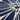 A close-up of a navy blue fabric with a cream-colored abstract floral or sunburst pattern.