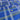 Blue fabric with a geometric pattern of white and yellow lines and circular motifs.