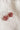 A pair of silver hoop earrings with faceted dusty rose pink flower-shaped 