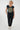 A woman modeling a dark navy blue t-shirt with a large circular gold and beige sunburst graphic on the front, 