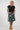 A woman modeling a black short-sleeve top and a knee-length A-line skirt with a multicolor top