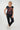 A woman modeling a navy blue short-sleeve t-shirt with a rust-orange abstract pattern, 