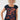 A smiling blonde woman wearing a navy blue scoop-neck t-shirt with a rust-orange abstract pattern 