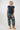 A woman modeling a navy blue short-sleeve t-shirt and patterned barrel-leg pants 