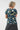 short-sleeve top with a dark teal abstract pattern in pastel yellow, blue, pink, and white, 