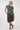 short-sleeve  top with a multicolor abstract pattern on a dark teal background, 