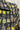 A close-up of a black fabric with a colorful pattern of potted plants,