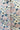  a button-front shirt with a light blue base and a repeating floral print in white, pink, and black.