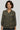 Woman wearing a patterned shirt against a plain background