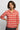 Woman wearing a red floral patterned shirt on a plain background
