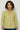  a yellow button-up shirt with a white and yellow floral pattern, paired with blue jeans