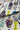 Fabric with colorful patterns of vases and abstract shapes on a white background