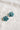 A pair of silver hoop earrings with faceted teal blue flower-shaped drops, 