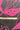 A close-up of a dark charcoal gray fabric with a bright pink botanical leaf pattern, featuring a wooden yardstick laid horizontally for scale.